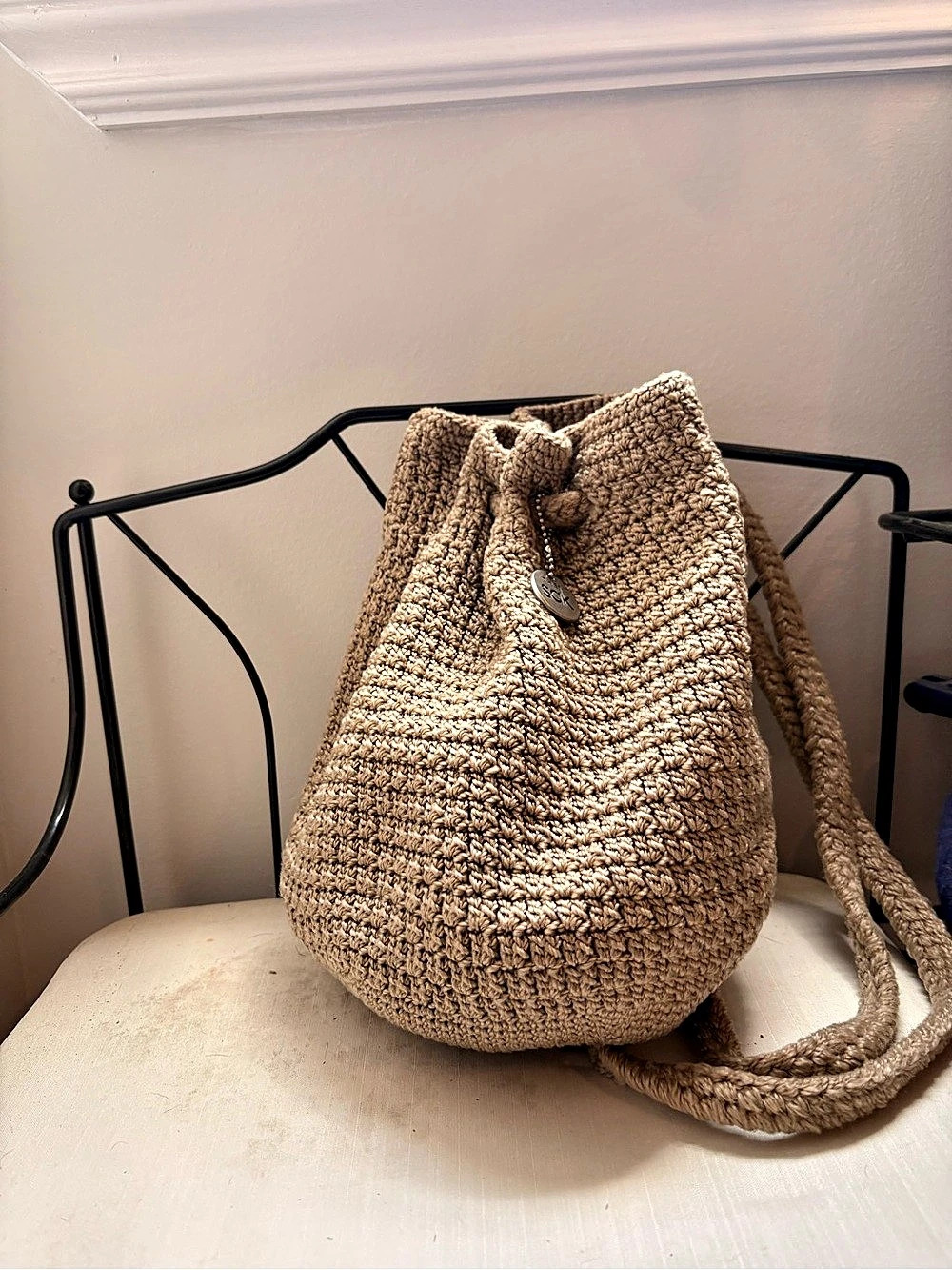 The Sak Crochet Drawstring Mini Backpack in Taupe